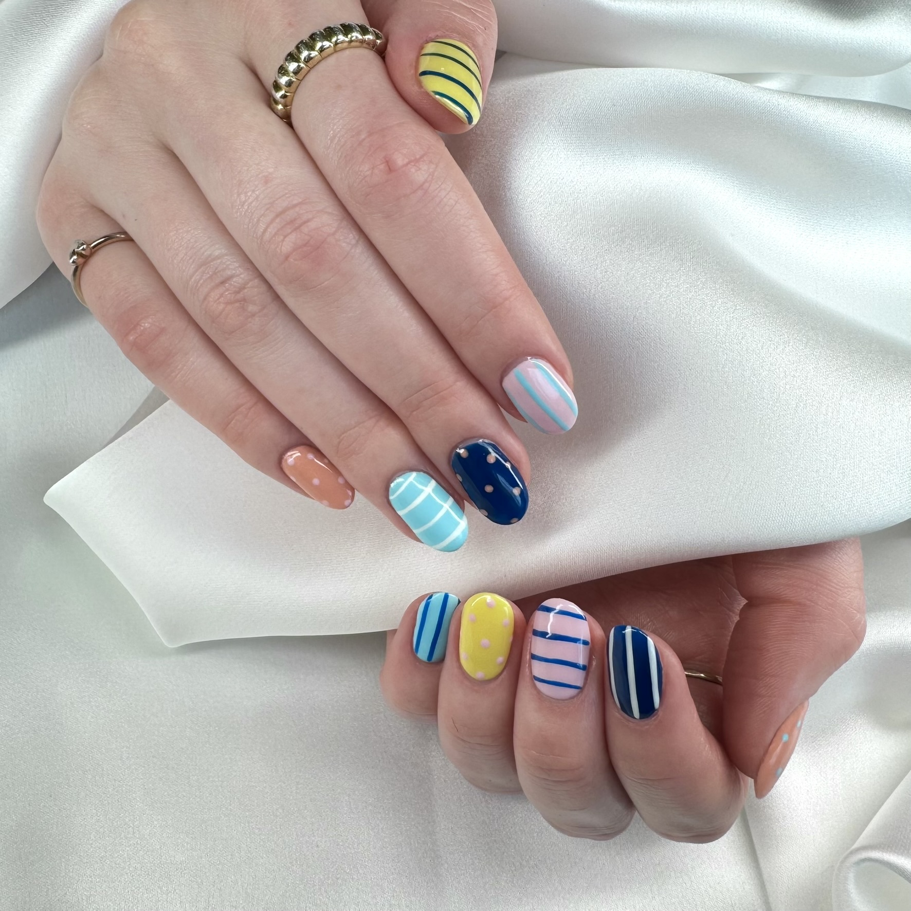 Pastel striped and polka dot mix-and-match manicure by TwentyOne Nails and Spa London Ontario