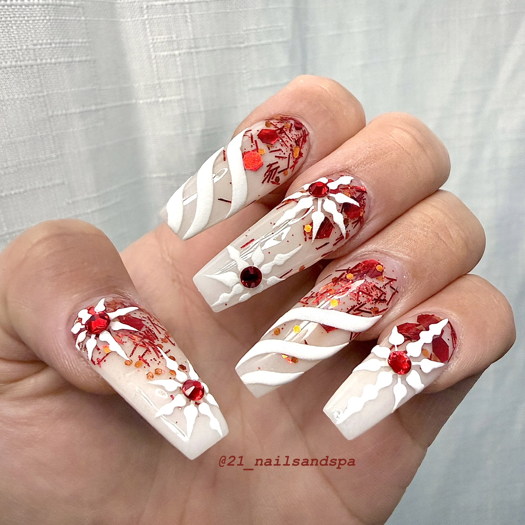 Long coffin nails with white snowflake art, red gems and glitter London Ontario