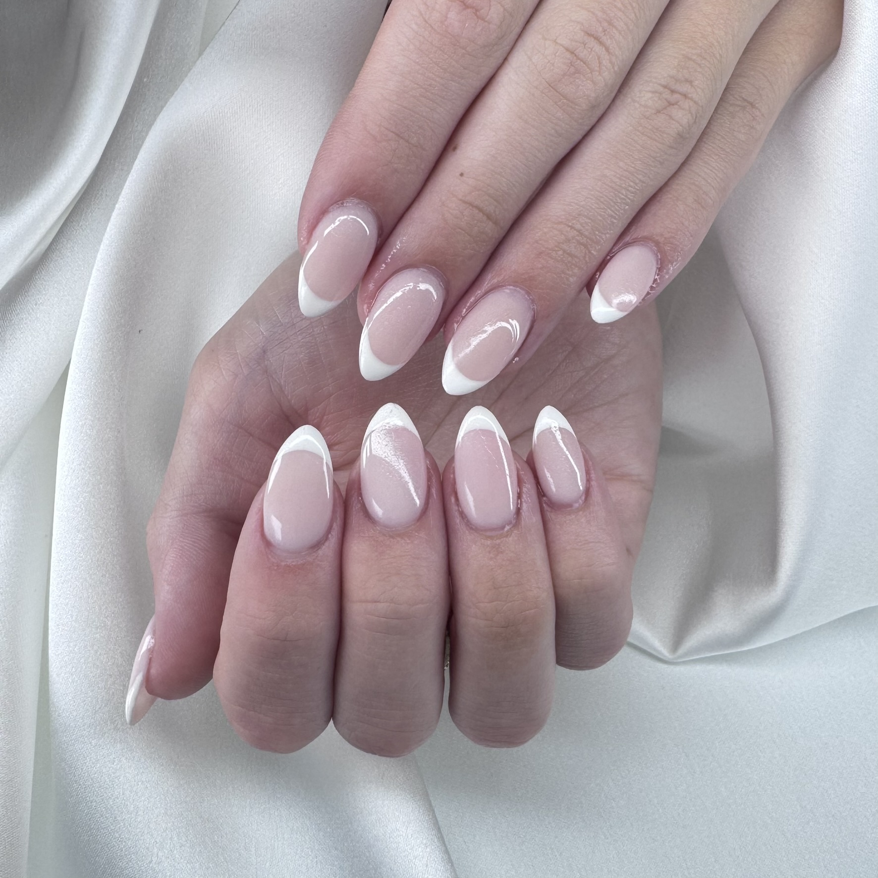 Classic white French tip almond nails by TwentyOne Nails London Ontario