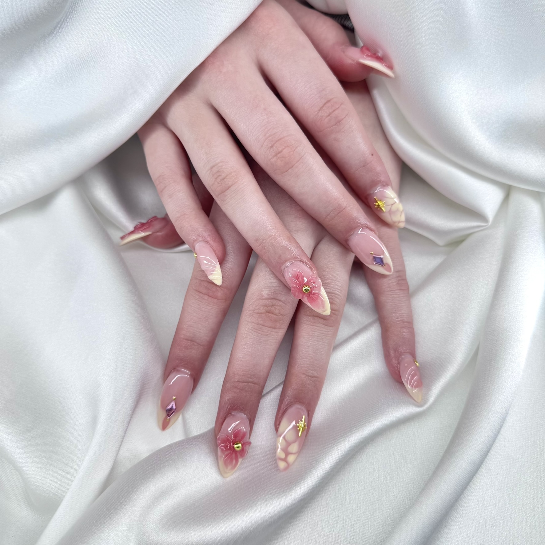 Nude almond nails with 3D pink floral accent and gem detail London Ontario